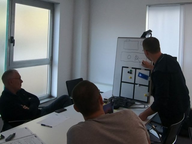 OKOndt GROUP's expert using the illustrations explains the operating principle of the UT probes — Italian customer's office, Fall 2019