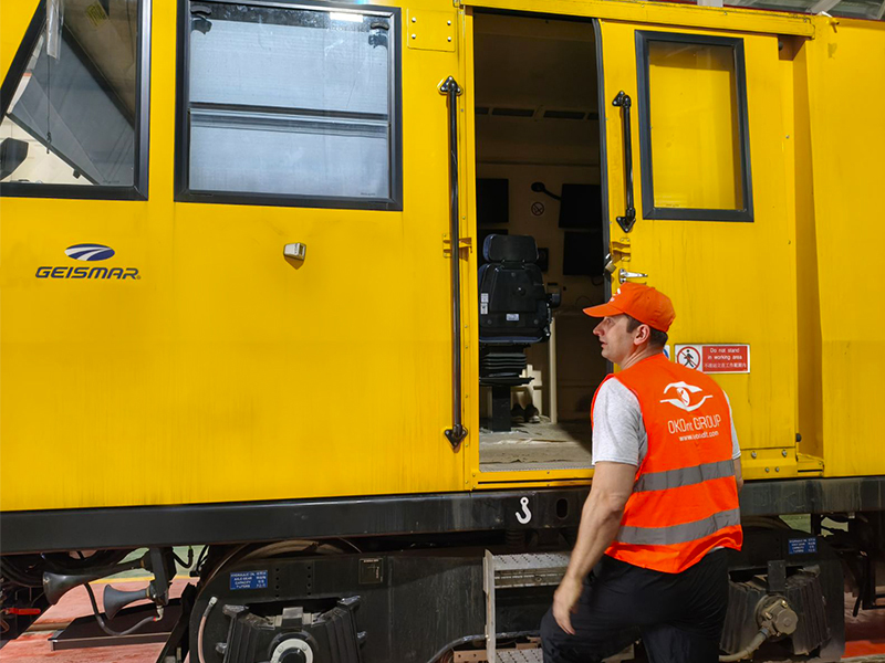 OKOndt GROUP specialist preparing a railway inspection vehicle for commissioning of an ultrasonic rail testing system.